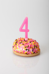 colorful birthday cake with candle for four