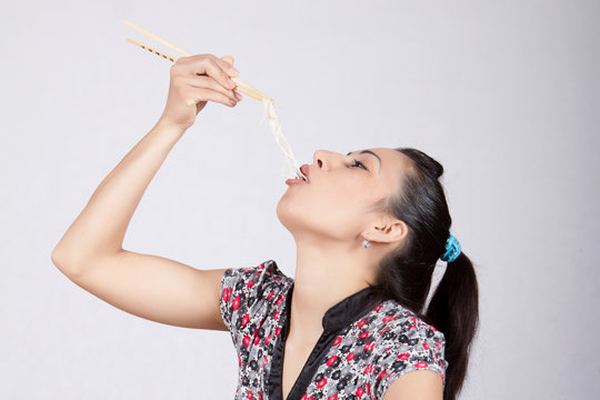 Woman eat noodles