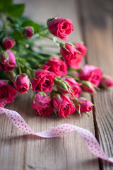 Pink roses on a wooden table