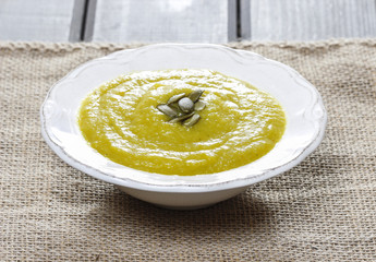 Creamy onion soup on wooden table