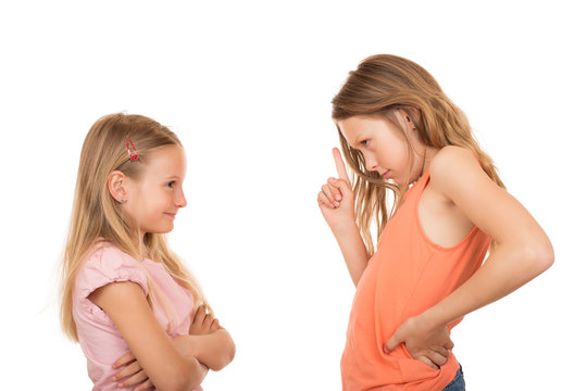 Young girl pointing finger at her sister