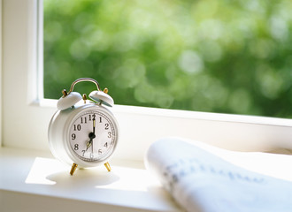 Newspaper and Alarm clock