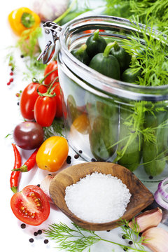 preparing preserves of pickled cucumbers and tomatoes