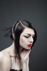 Fototapeta premium Brunette woman with long straight hair on dark