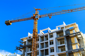 Apartments construction site with yellow crane