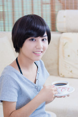 young asian girl enjoying coffee
