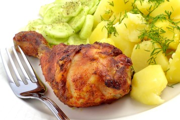 grilled chicken leg with potatoes and cucumber