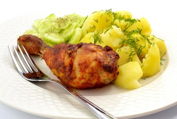 grilled chicken leg with potatoes and cucumber