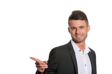 Happy modern businessman pointing - on white