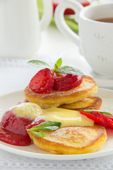 Pancakes with strawberries, strawberry sorbet and vanilla sauce.