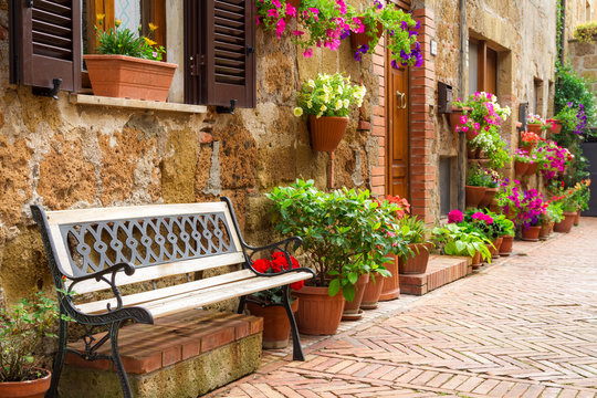 Fototapeta Beautiful street decorated with flowers in Italy