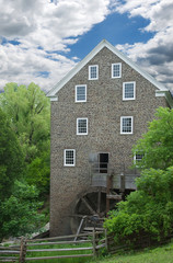 old flour mill powered entirely by wooden water wheel