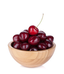 Ripe cherries in a wooden bowl