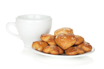 Various cookies in bowl and tea cup