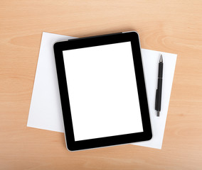 Tablet with blank screen over white papers