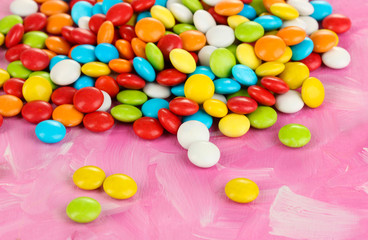 Fototapeta na wymiar Colorful candies on pink background