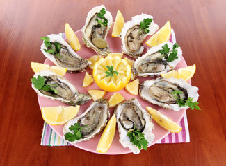 Oysters on wooden background