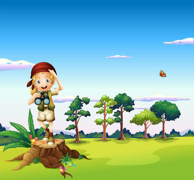 A girl with a telescope standing above a stump