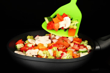 Vegetable ragout in pan, isolated on black