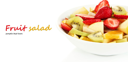 Useful fruit salad of fresh fruits and berries in bowl isolated