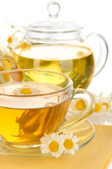 Cup of herbal tea with camomiles close up