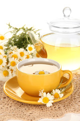 Cup of herbal tea with camomiles close up