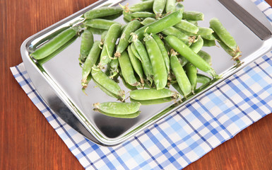 Green peas on napkin on table