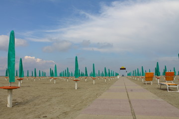 beach with closed umbrellas