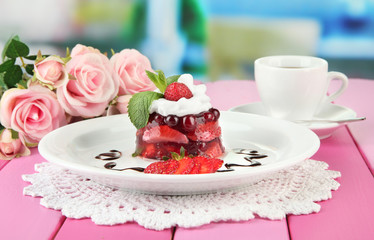 Tasty jelly dessert with fresh berries, on bright background