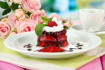 Tasty jelly dessert with fresh berries, on bright background