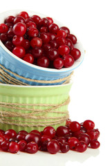 Ripe red cranberries in bowls, isolated on white.