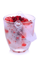 Frozen berries in bucket of ice isolated on white