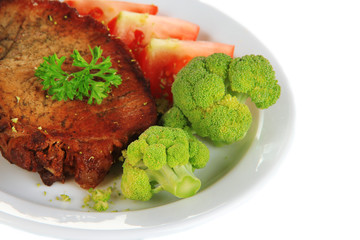Piece of fried meat on plate isolated on white