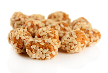 Tasty peanuts with sesame and caramel, isolated on white