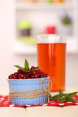 Glass of cranberry juice and ripe red cranberries in bowl