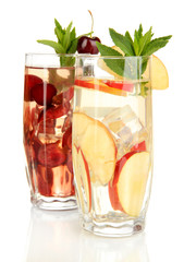 Glasses of fruit drinks with ice cubes isolated on white