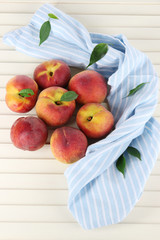 Peaches on napkin on wooden table