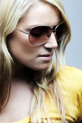 Close-up portrait of blond woman with sunglasses