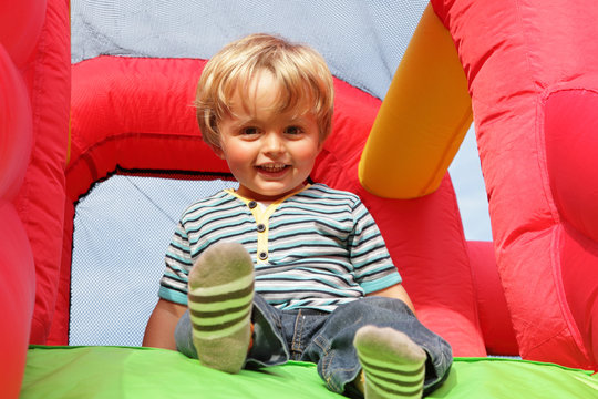 Child on inflatable bouncy castle