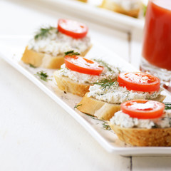 Breakfast of cottage cheese bruschettas and tomato juice