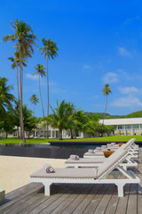 Spa beds with towels and flowers on tropical beach resort