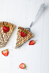 Slice of cheesecake with strawberry on cake lifter
