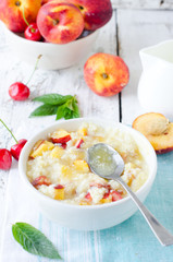 .Milk porridge with peaches and cherries