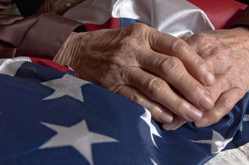 Hands holding an American flag - obrazy, fototapety, plakaty