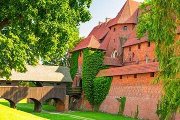 The wall and towers of Malbork castle in summer scenery, Poland