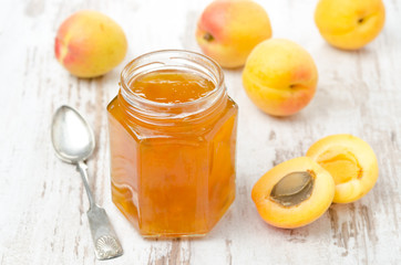 apricot confiture in a glass jar and fresh apricots, horizontal