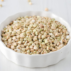 green buckwheat in a white bowl