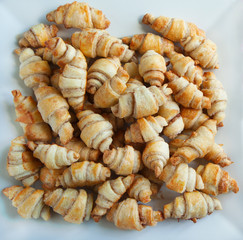 Rugelach with cinnamon and sugar filling in bowl on the wooden t