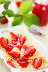 Fried pancakes with strawberries jam