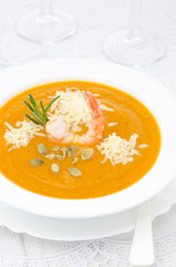 pumpkin soup with shrimp, Parmesan and rosemary vertical closeup